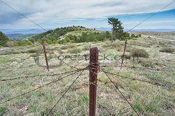 Abandoned military zone with rusty spiked fence