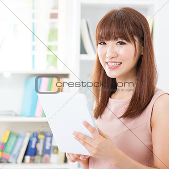 Asian female using tablet