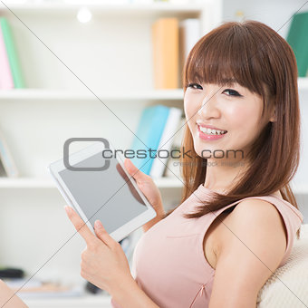 Asian girl using touch screen tablet 