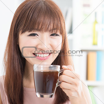 Asian girl enjoying coffee