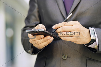 Business Man Typing With Pen On  Smartphone