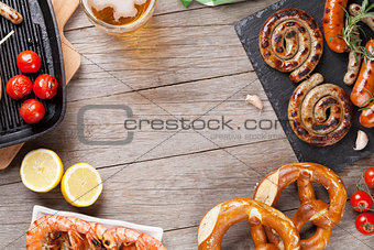 Beer mug, grilled shrimps, sausages and pretzel