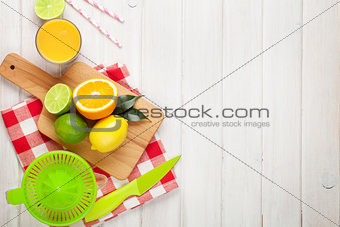 Citrus fruits and glass of juice. Oranges, limes and lemons