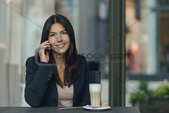 Smiling woman chatting on her mobile