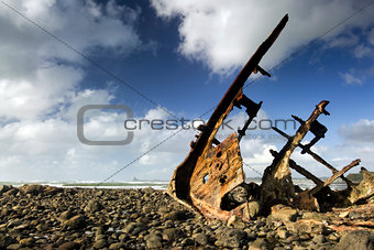 Shipwreck on beach at low tide, New Plymouth, New Zealand