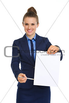 Businesswoman holding up blank paper, pointing with pen