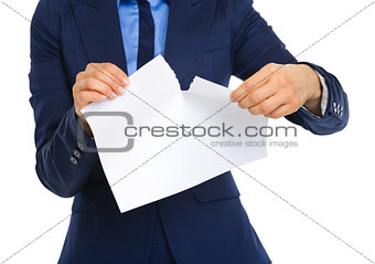 Closeup of businesswoman's hands ripping a piece of paper