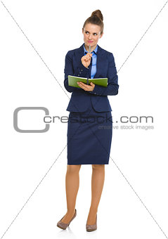 Elegant businesswoman holding notebook with pen on chin
