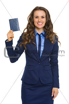 Elegant businesswoman holding up passport and smiling