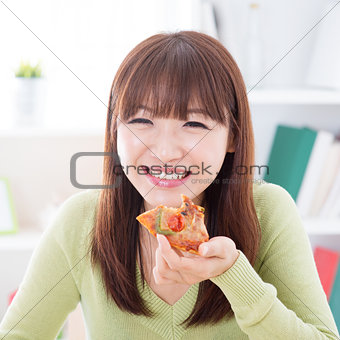 Asian girl eating pizza
