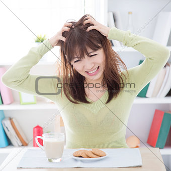 Asian girl feeling bored with her breakfast