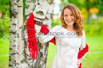 cheerful and beautiful girl in a dress in the spring park