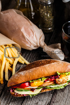 Chicken sandwich, fries and glass of soda