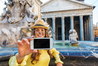 Closeup of woman's hand holding mobile while taking selfie