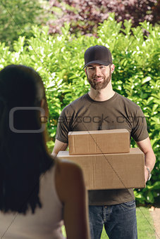 Woman answering the door to a deliveryman