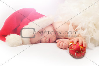 Small boy sleeping in a New Year's cap