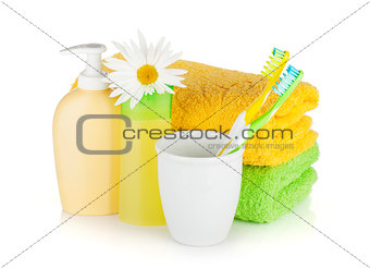 Toothbrushes, shampoo bottles, two towels and flowe