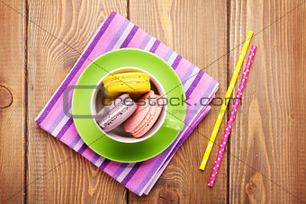 Colorful macaron cookies in coffee cup