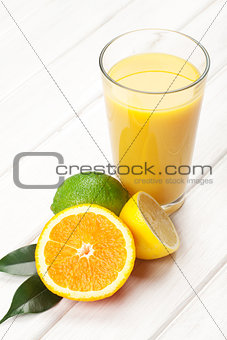 Citrus fruits and glass of juice. Orange, lime and lemon.