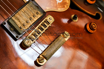 Side view of old brown electric guitar