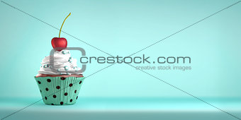 Delicious cupcake topped with a cherry and sweeties.