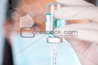 Closed up Nurse fills syringe from injection vial and chemical s