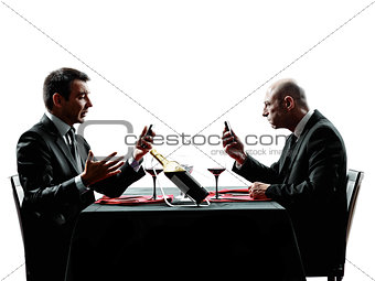 business using smartphones dinner silhouettes