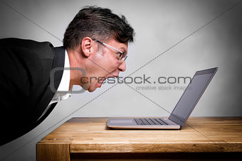 Man screaming at laptop