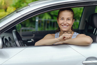 Smiling Pretty Woman Leaning on Car Window
