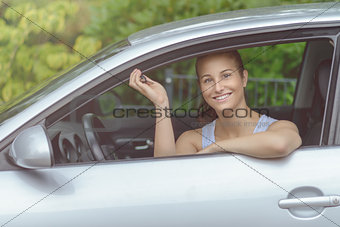 Smiling Young Woman in her Car Holding Keys