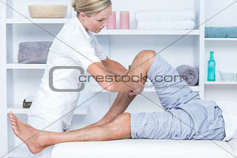 Physiotherapist doing calf massage to her patient