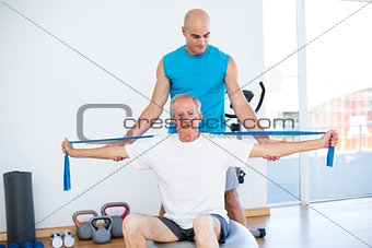 Trainer examining his patient back