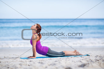Brunette doing yoga on exercise mat