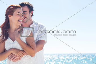 Happy couple hugging and laughing together
