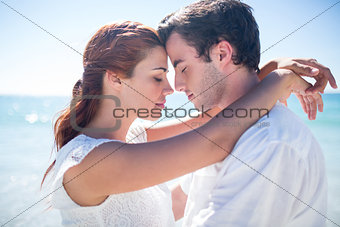 Happy couple hugging eyes closed
