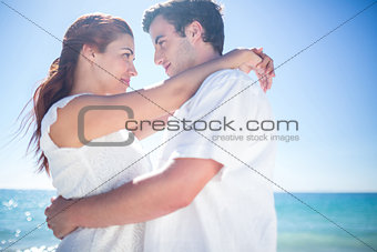 Happy couple hugging and smiling at each other