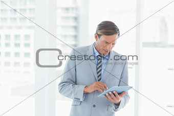 Concentrate businessman using tablet pc