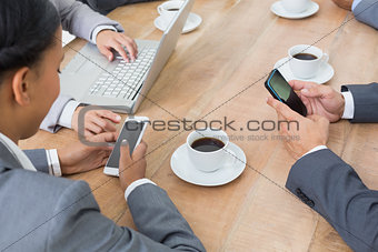 Business people in meeting with new technologies