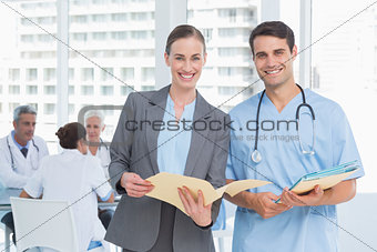 Male and female doctors with reports