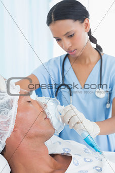 Doctor putting an oxygen mask