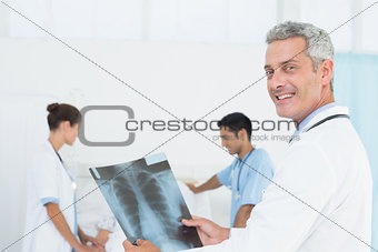 Male and female doctors examining x-ray