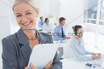 Smiling businesswoman holding a clipboard