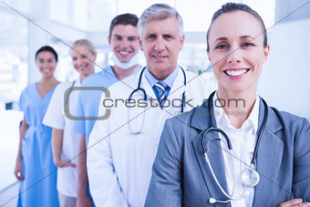 Smiling team of doctors standing in line