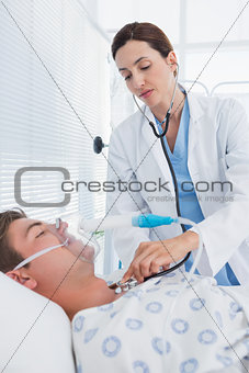 Doctor auscultating her patients chest