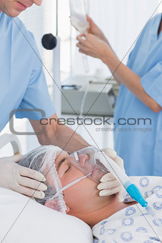 Doctor holding patients oxygen mask