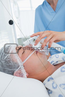 Doctor holding patients oxygen mask