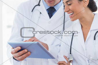Happy doctors looking at clipboard