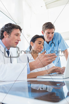 Team of doctors working on laptop computer