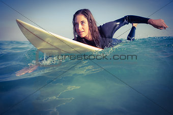 woman in wetsuit surfing