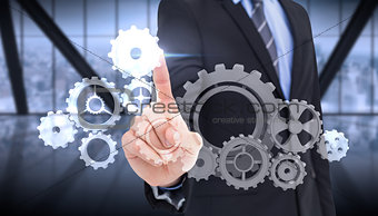 Composite image of mid section of businessman pointing something up